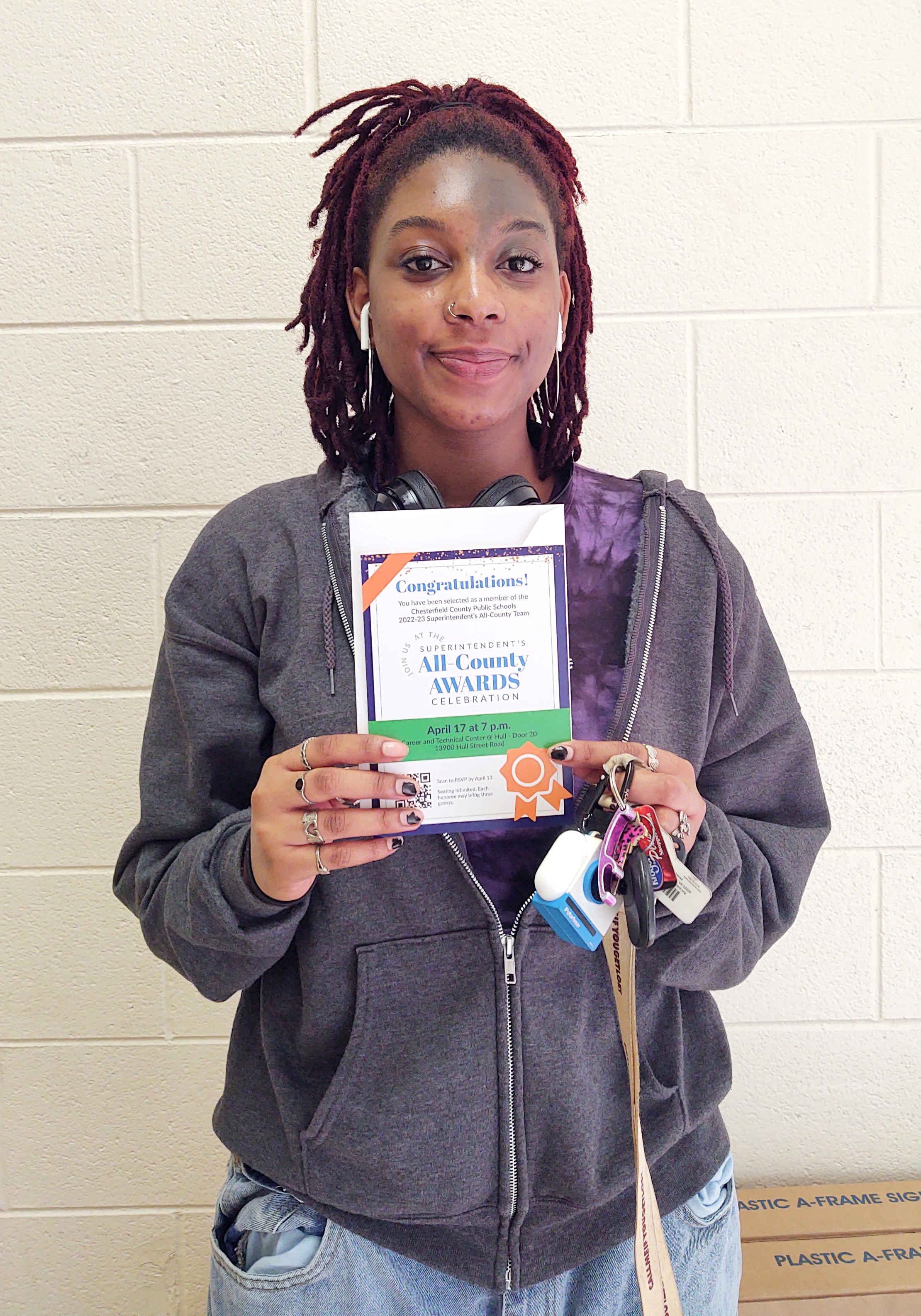 A girl holding an invitation to an awards event