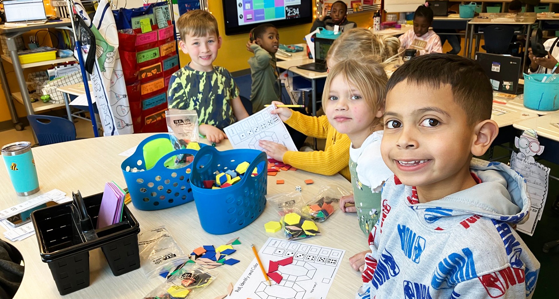 A group of students working on a class assignment with books