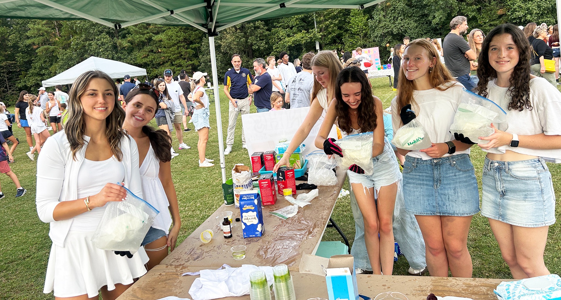 students helping at a fair