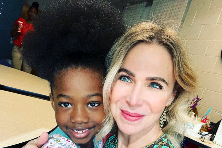 A teacher hugging a student