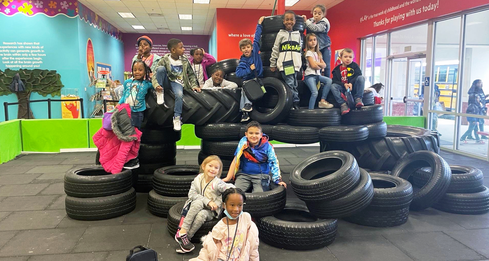 A group of kindergartners on top of tires