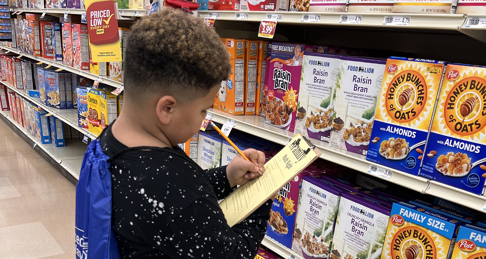 A student working on a homework assignment at the grocery store