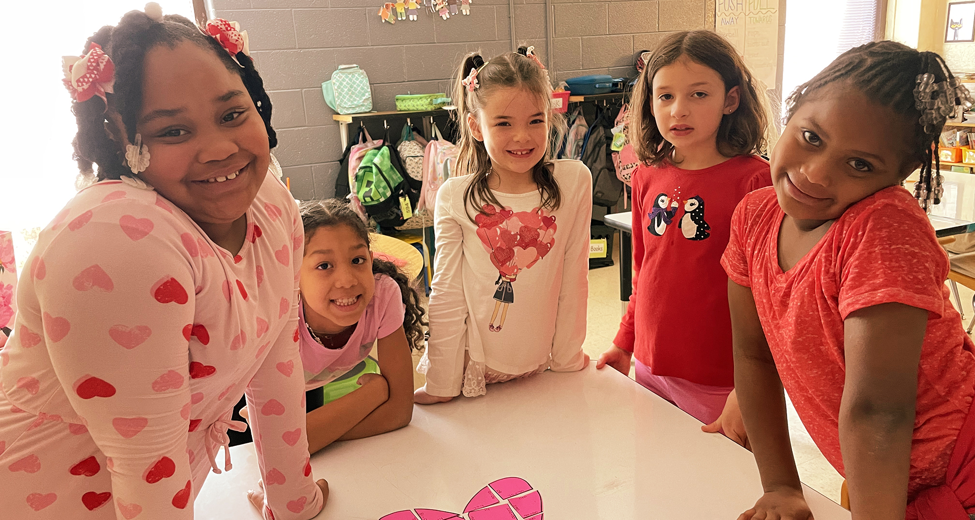 Five female students smile for a photo.