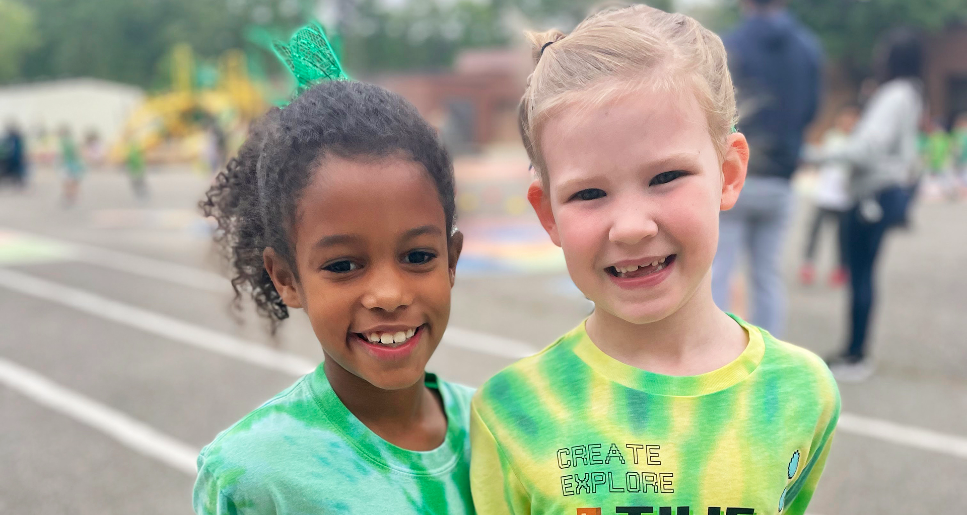 Two children smiling outside
