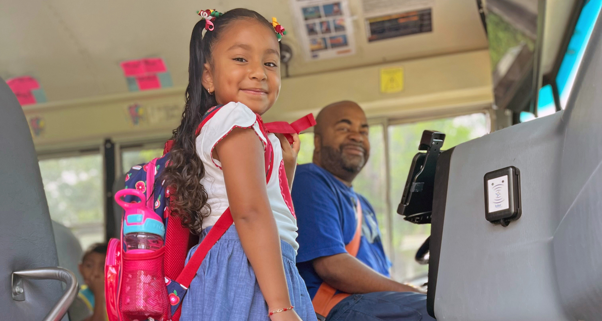 A little girl getting in a school bus