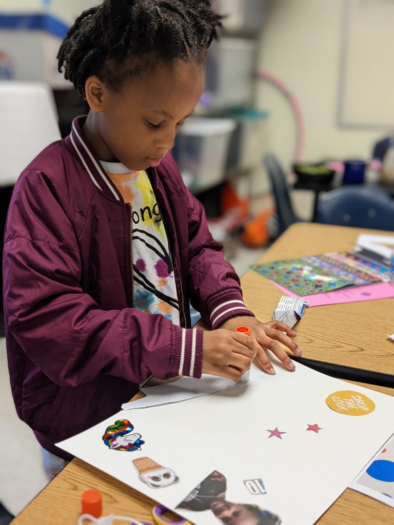 A girl using glue for part of her project