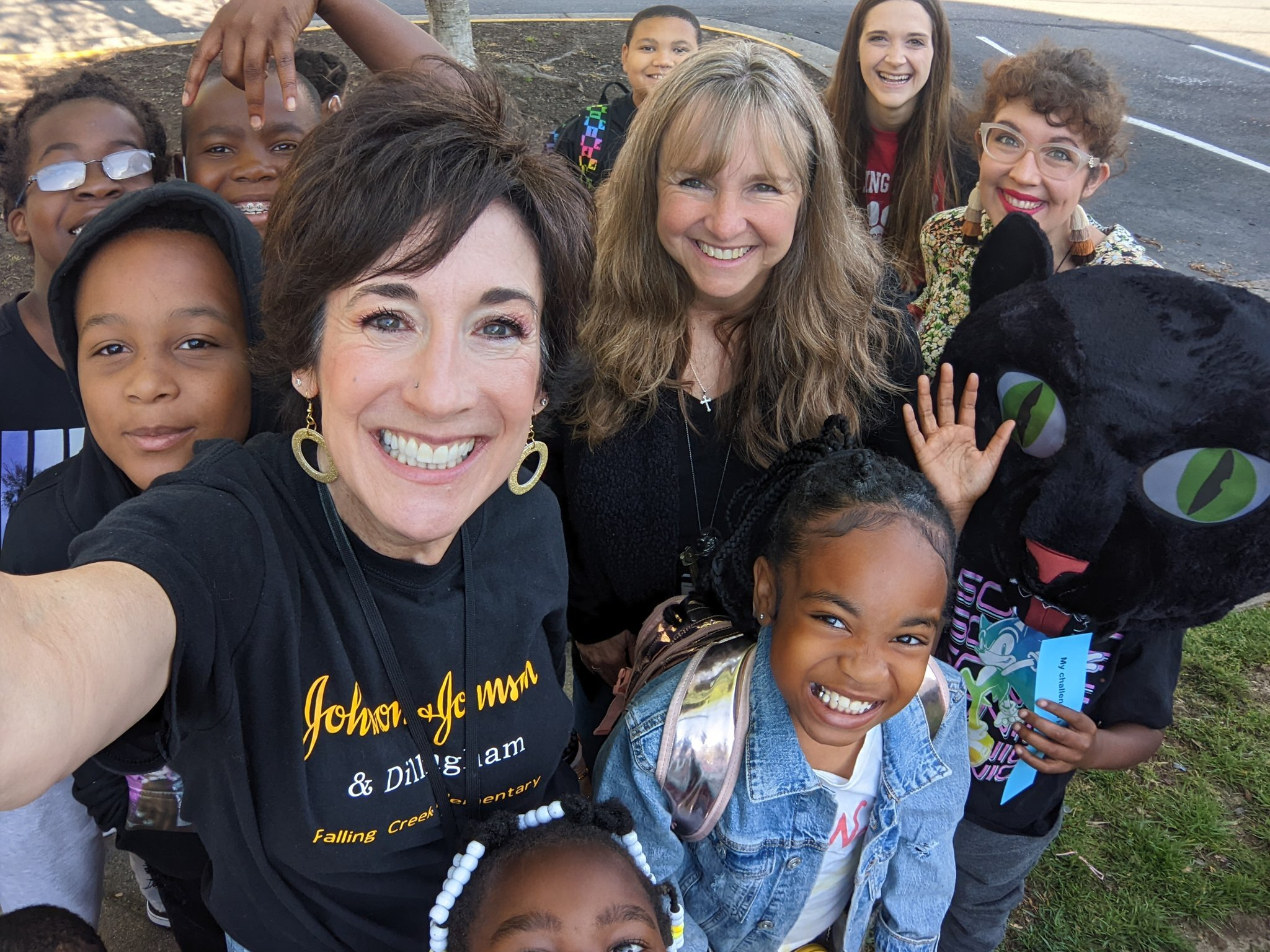 A staff member taking a selfie with a group of students