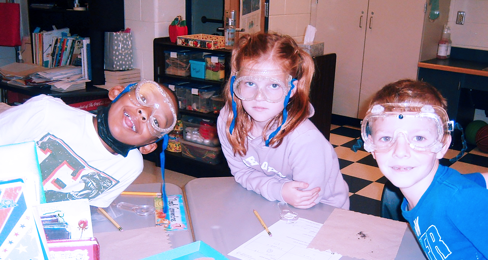 Three students wearing their science goggles.