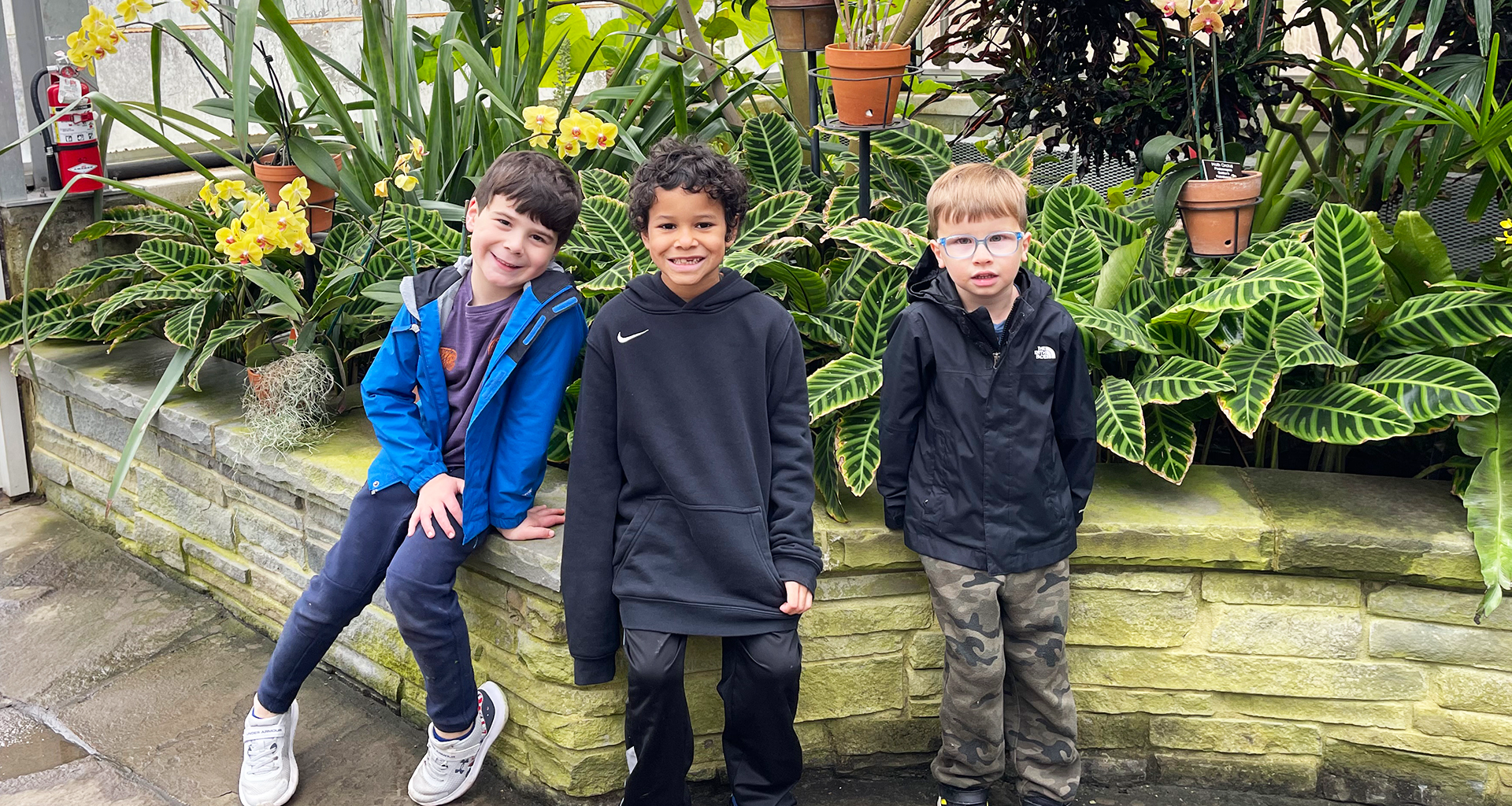 Three students pose at the botanical gardens.