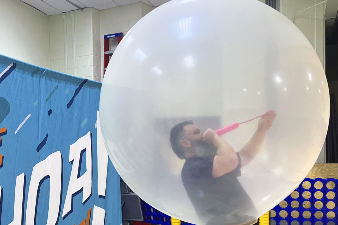 Teacher blowing a giant balloon