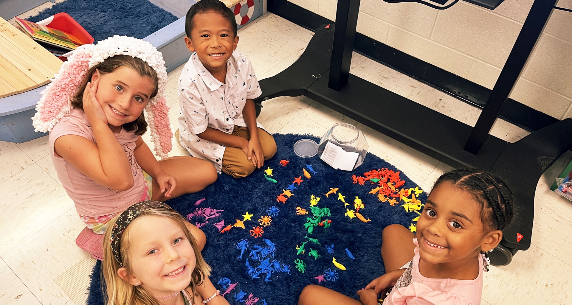 Four students sitting on the floor