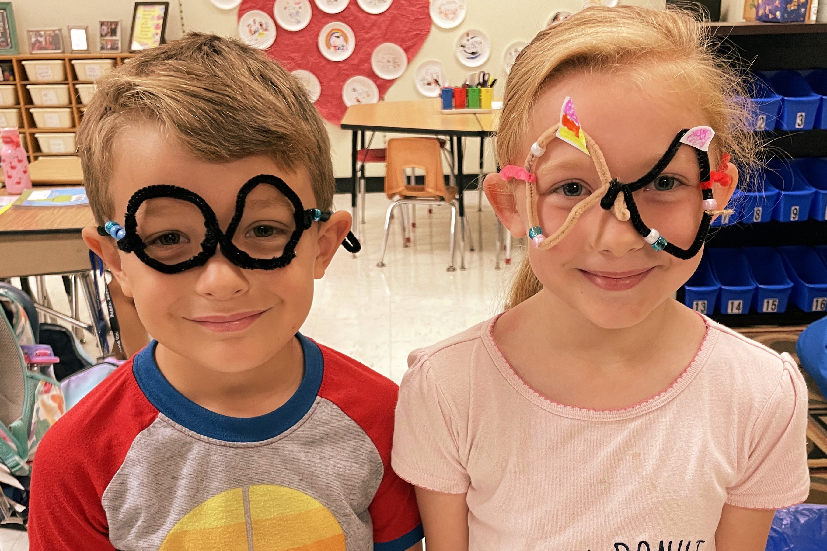 two students wearing their pipe cleaner glasses