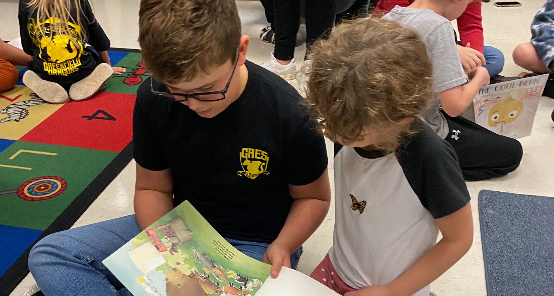 students looking at a book together