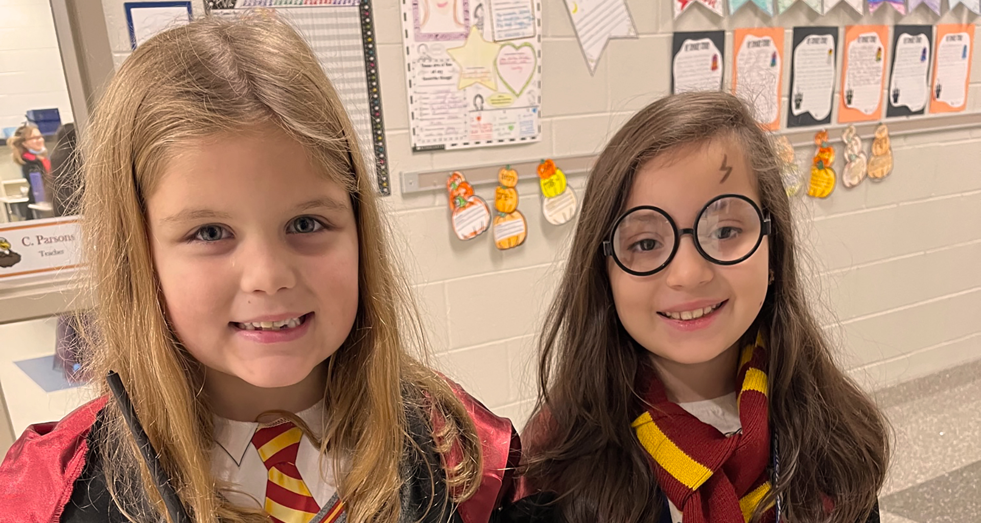 Two female students pose in the Harry Potter outfits