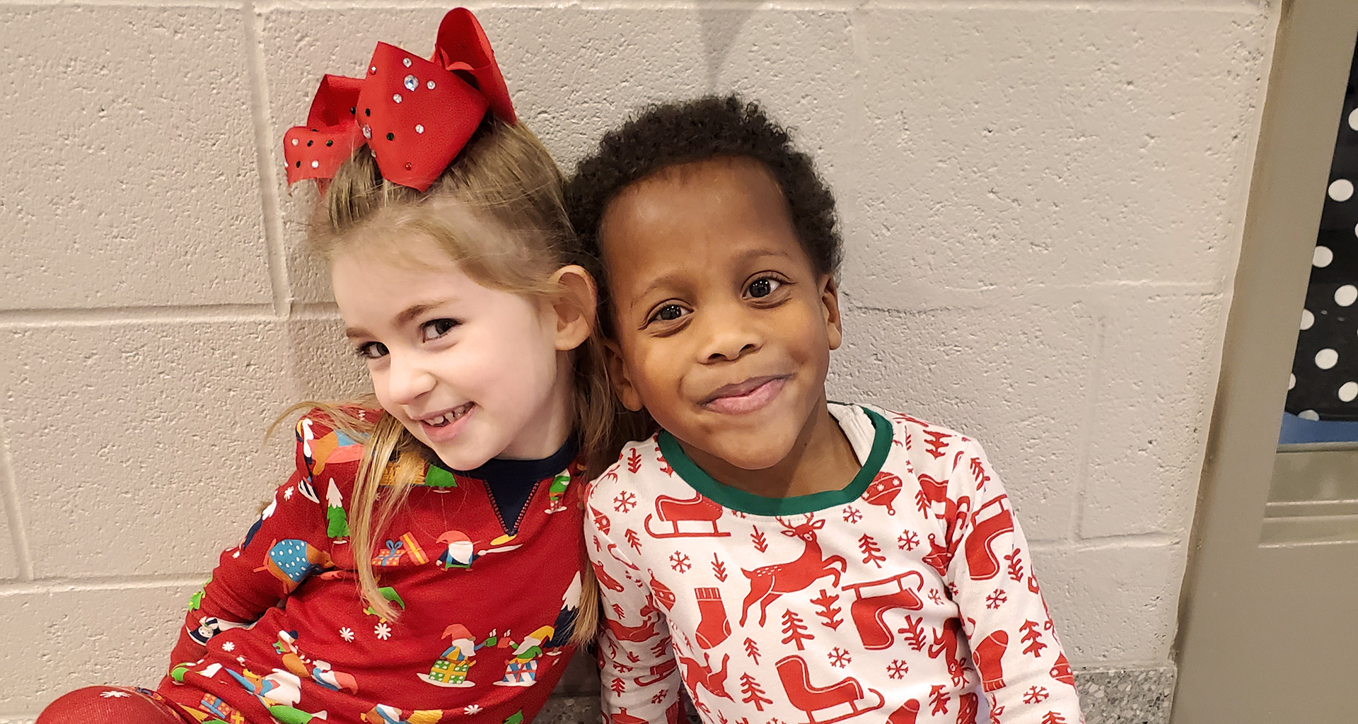 Two students pose for the camera on pajama day.