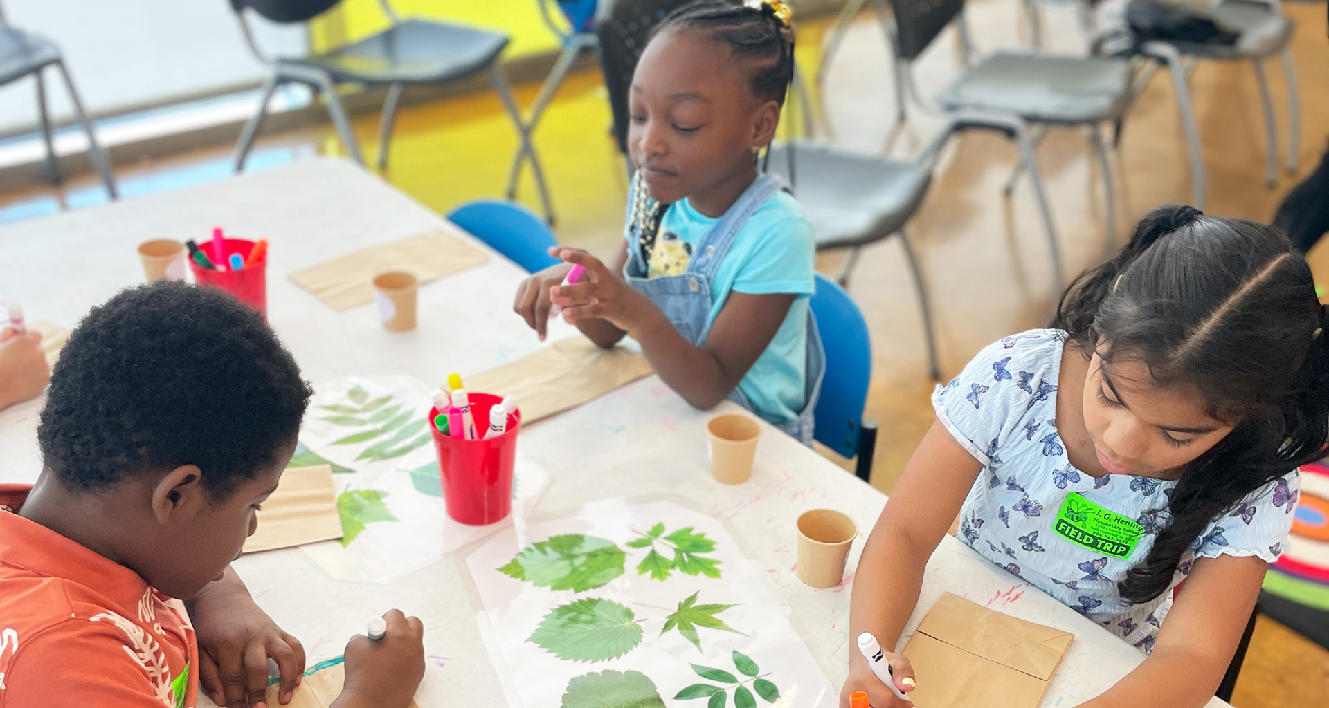 Three students working together at a table.