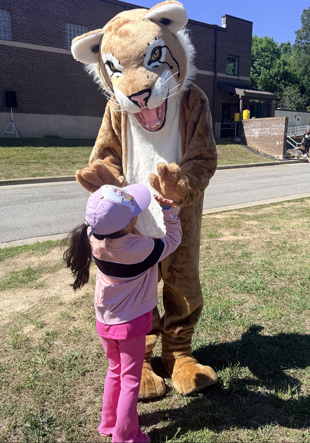 student high five's the mascot