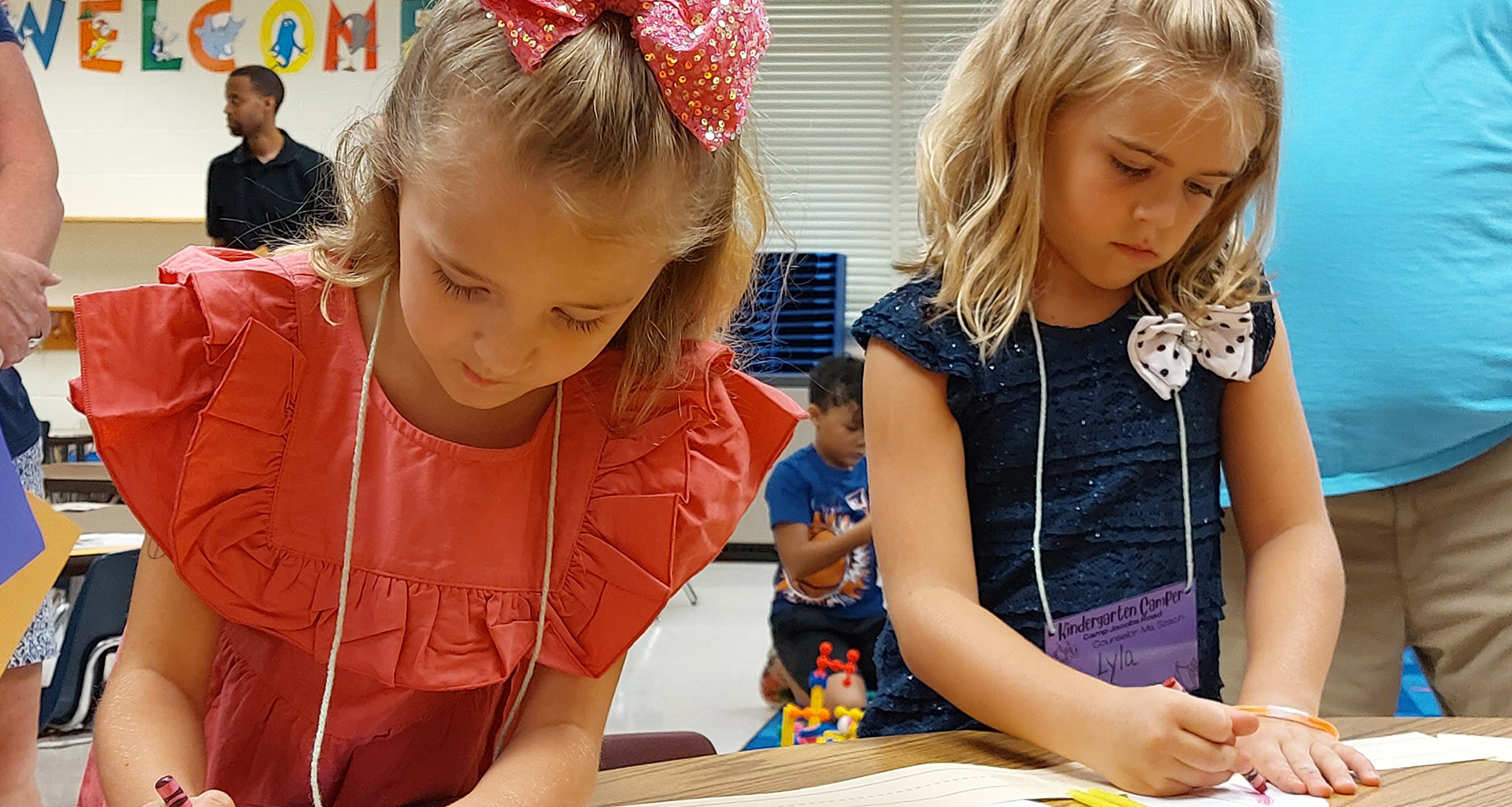 Two kindergartners coloring in class