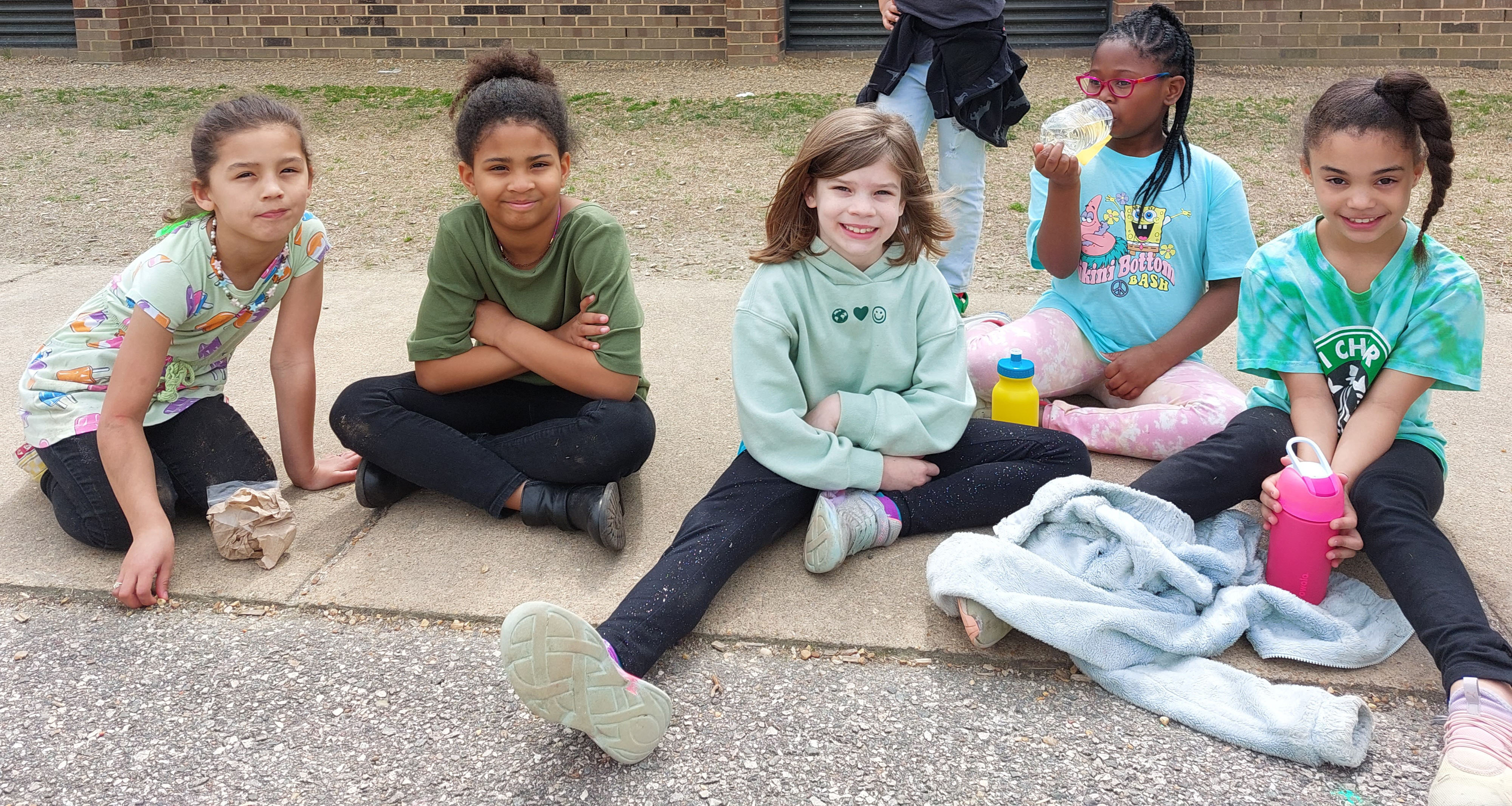 Five girls resting outside during field day