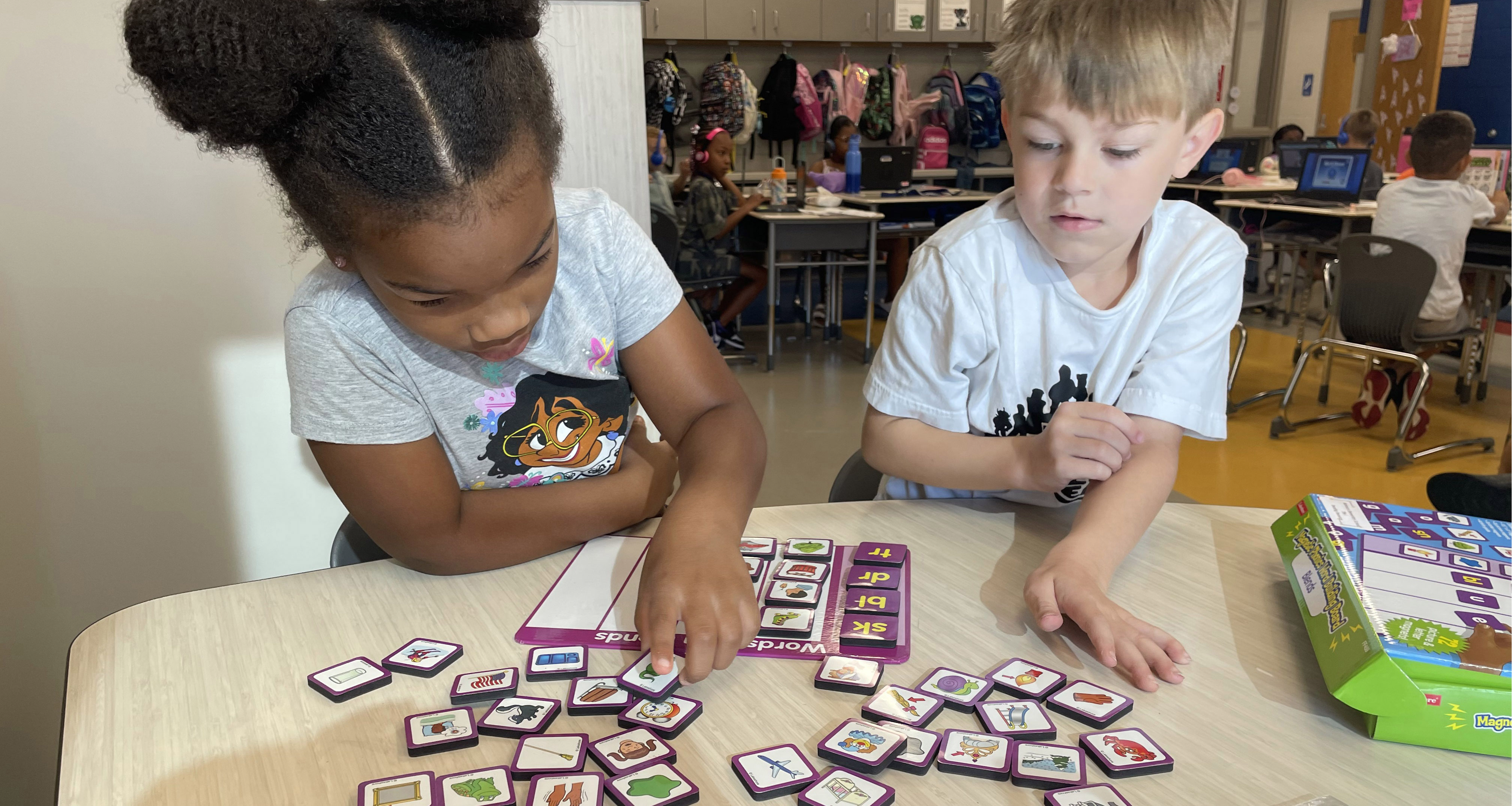Two students working together on a word matching game