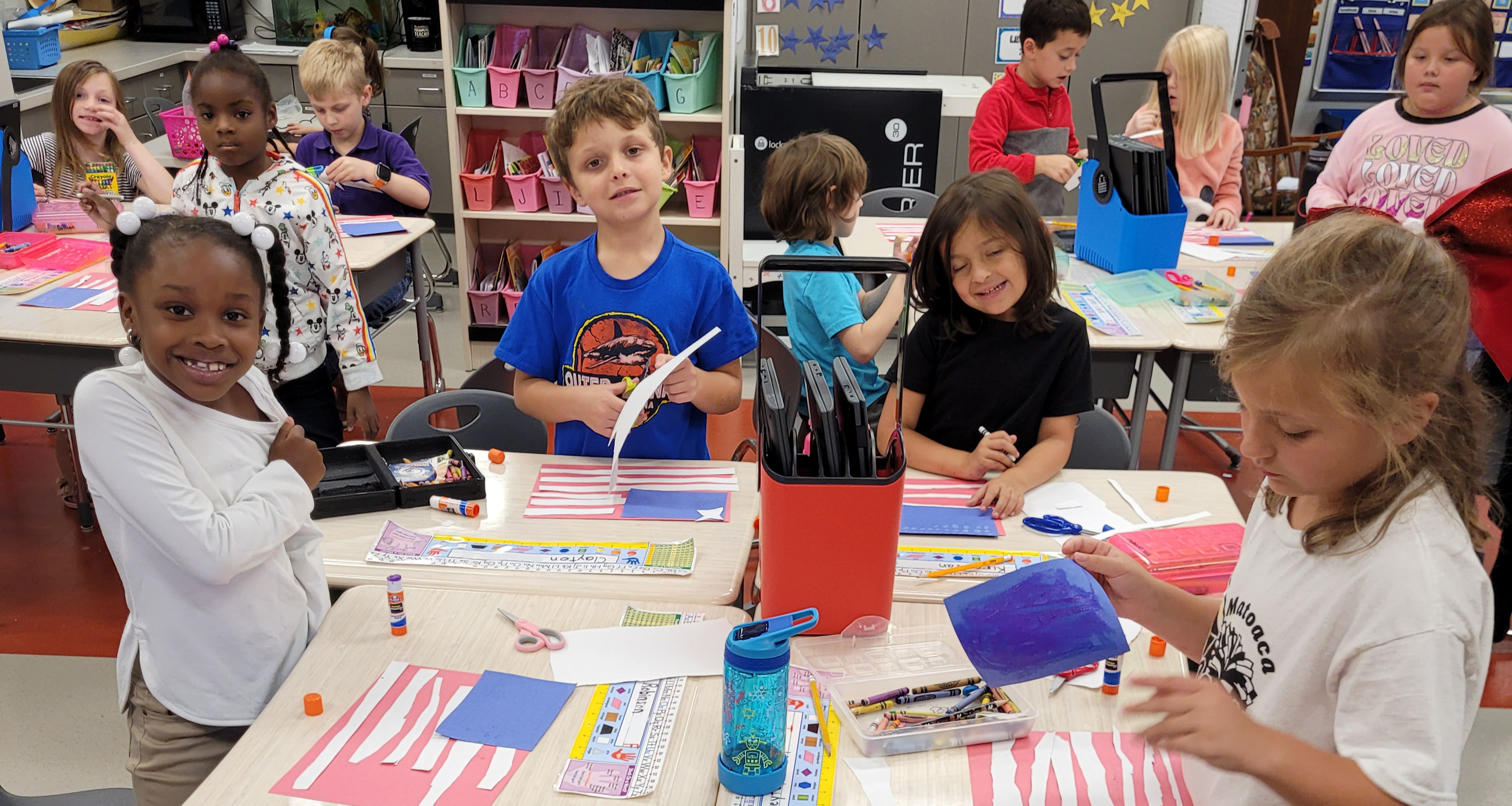 A group of student creating the U.S. flag with construction paper