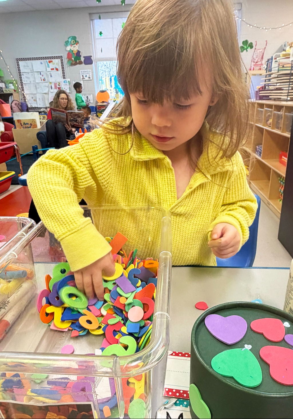 student playing with letters and numbers