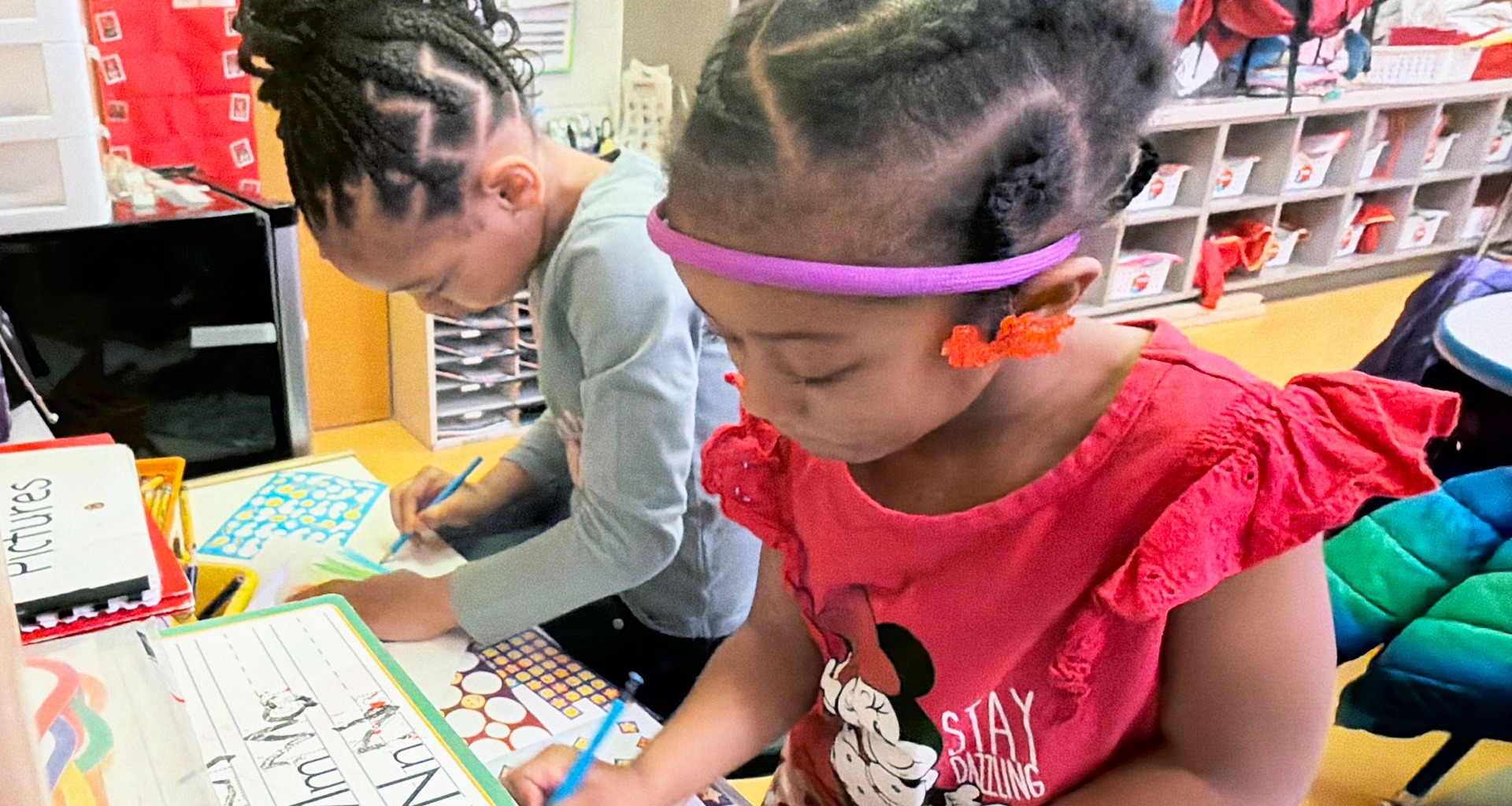 two student writing their names