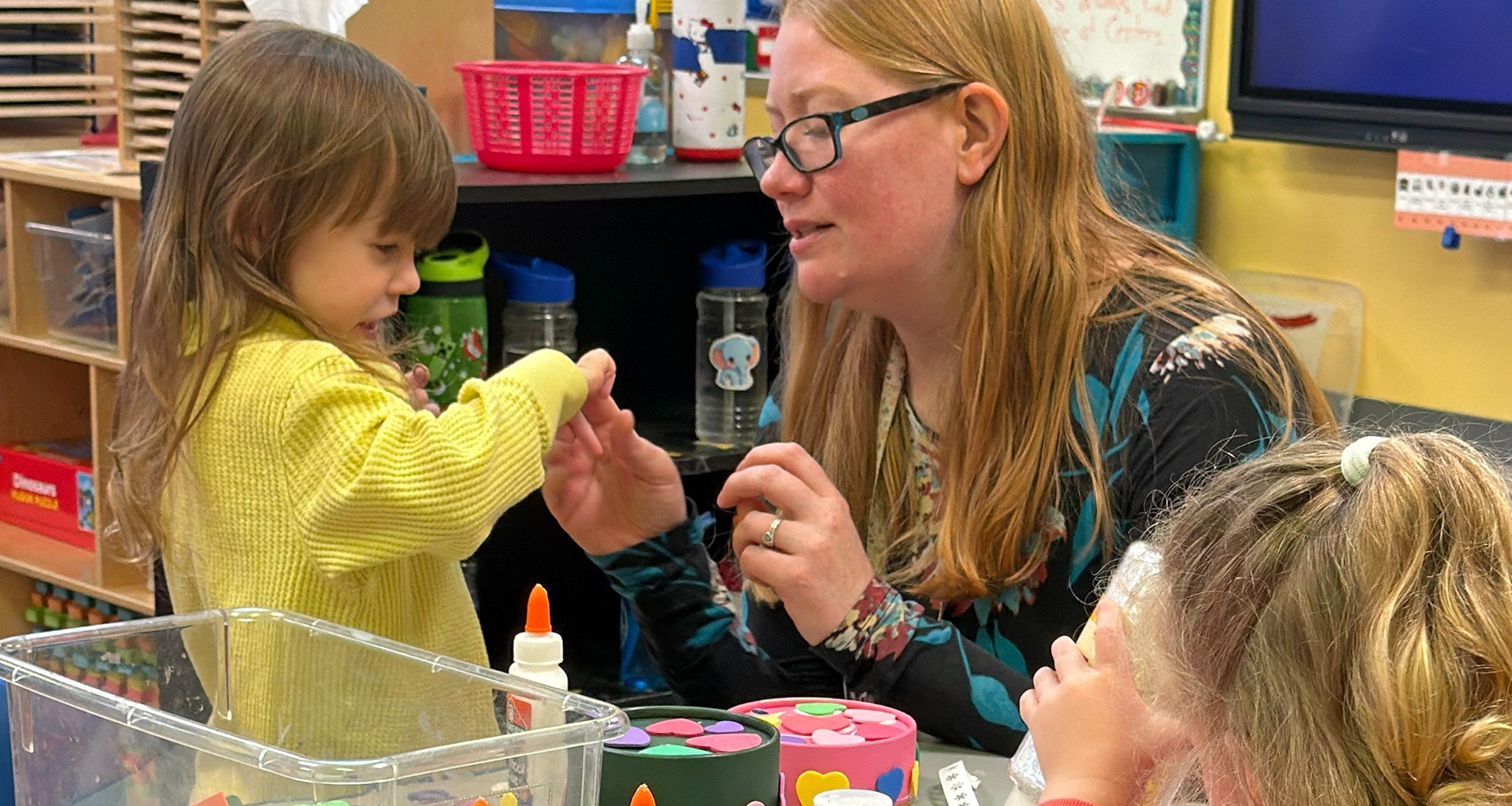 teacher helping young student