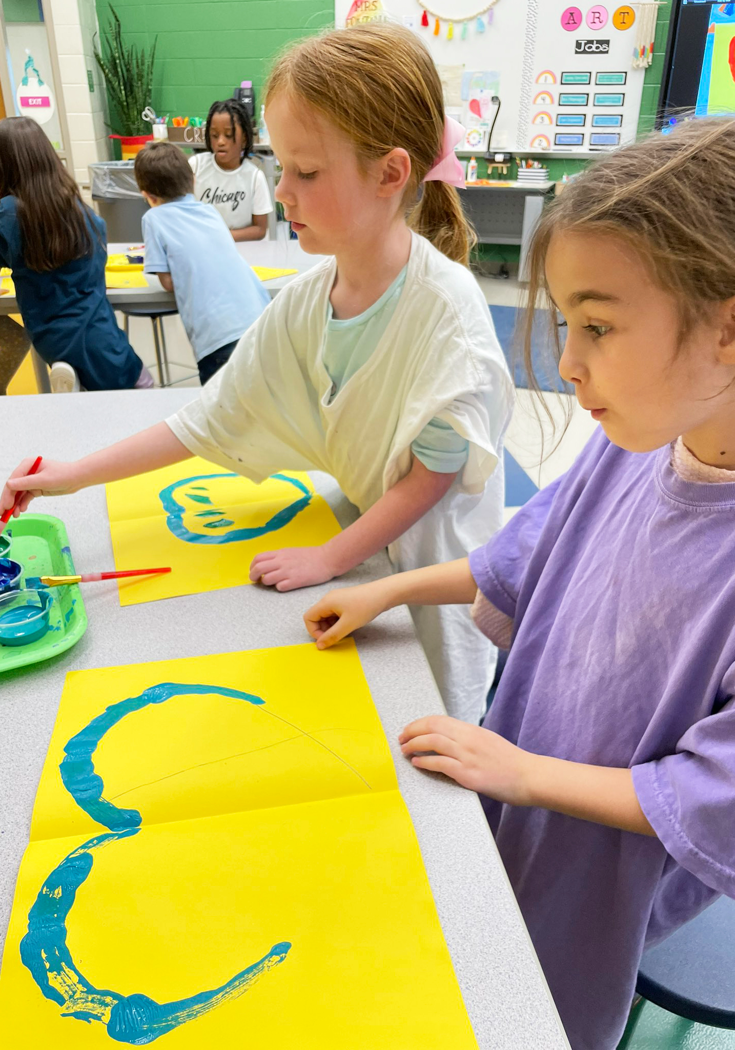 Two female students painting