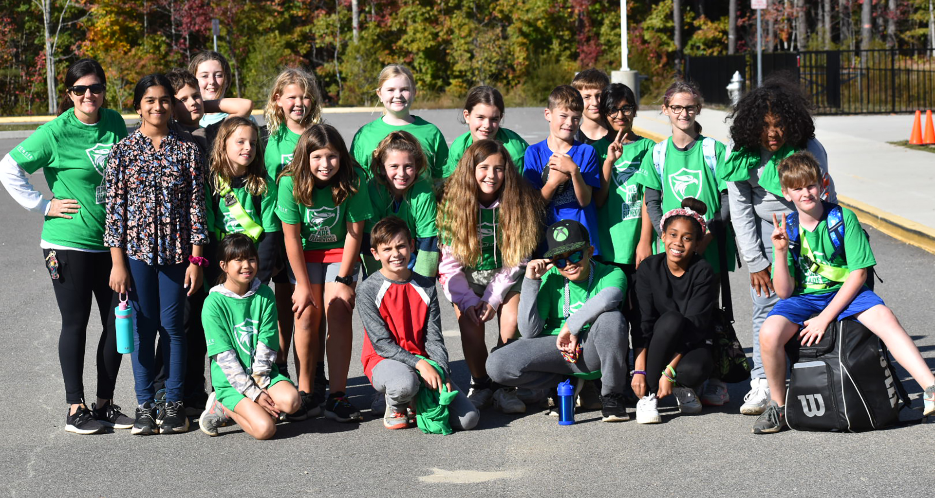 Large group of students outside pose for a photo.