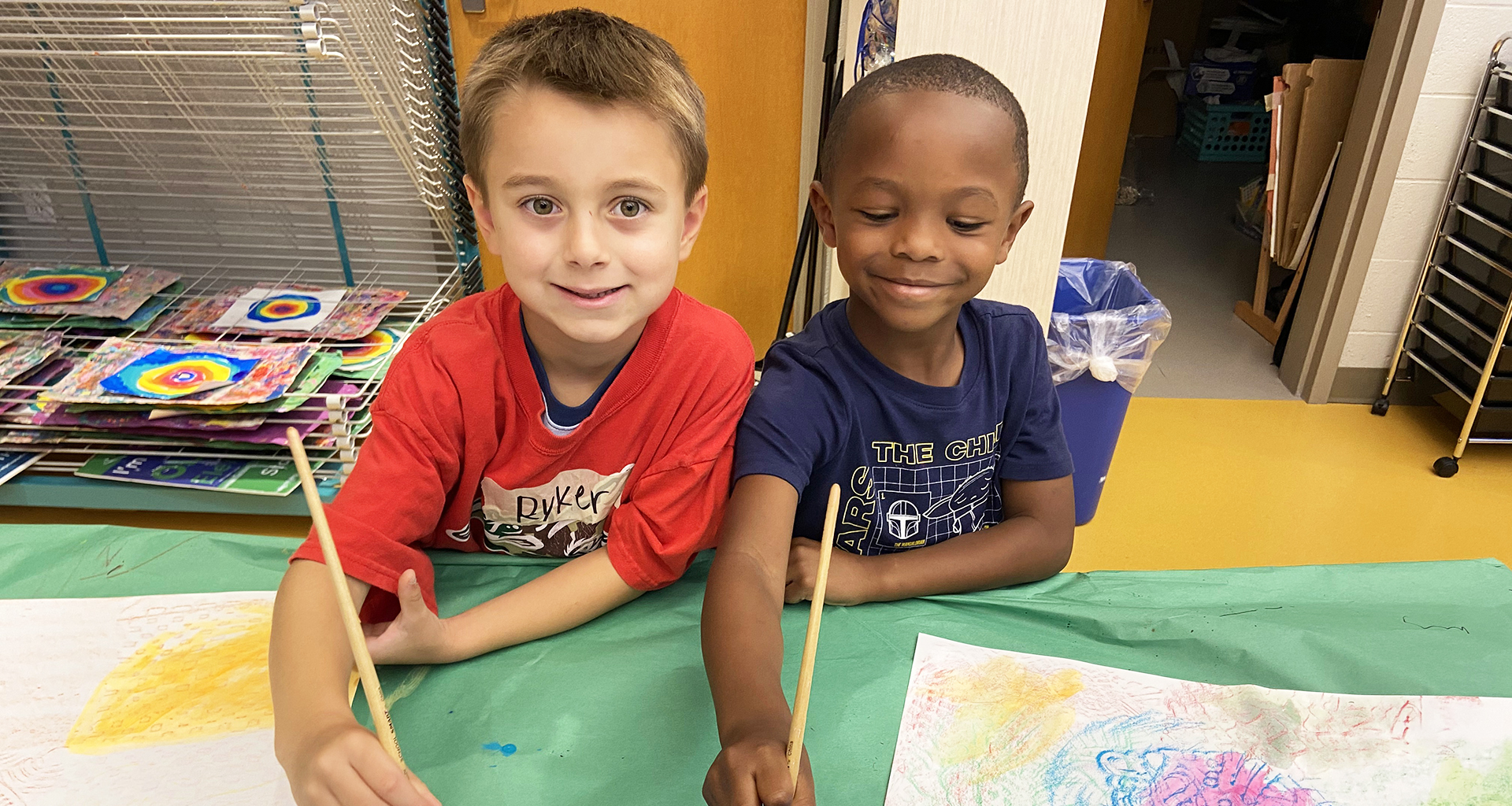 Two boys painting together.