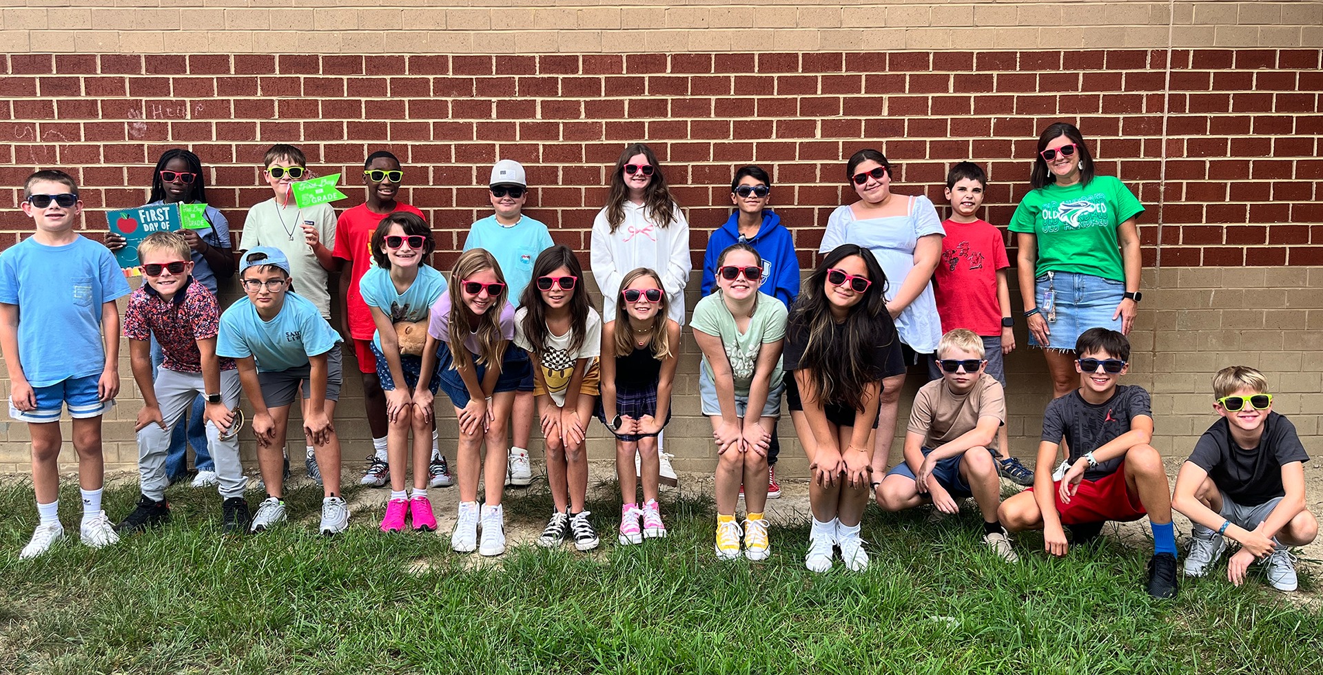 Class poses for a photo outside