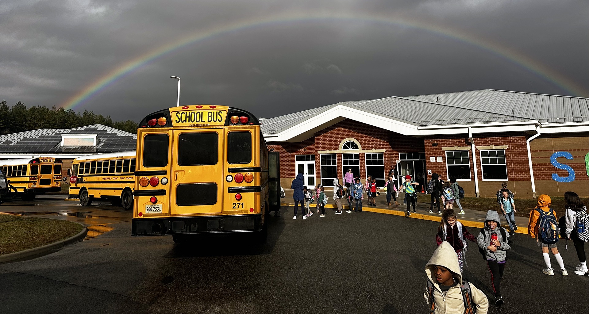 School with rainbow over it.