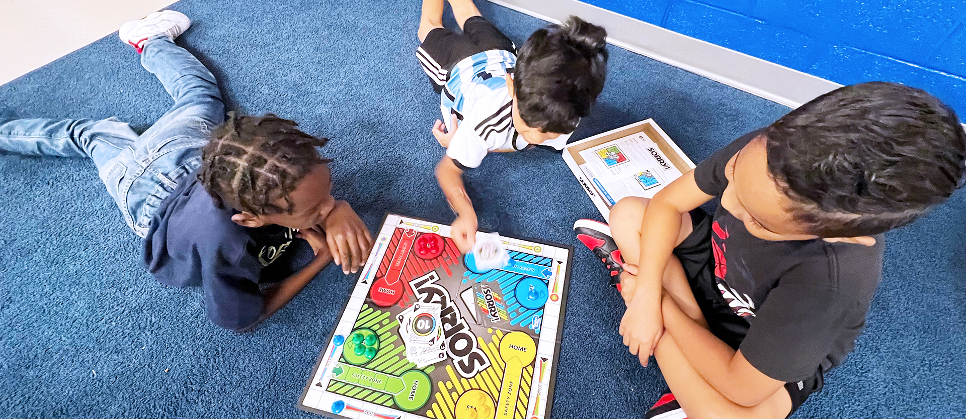 A group of students sitting on floor playing a game.