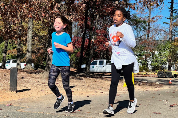 Two female students running