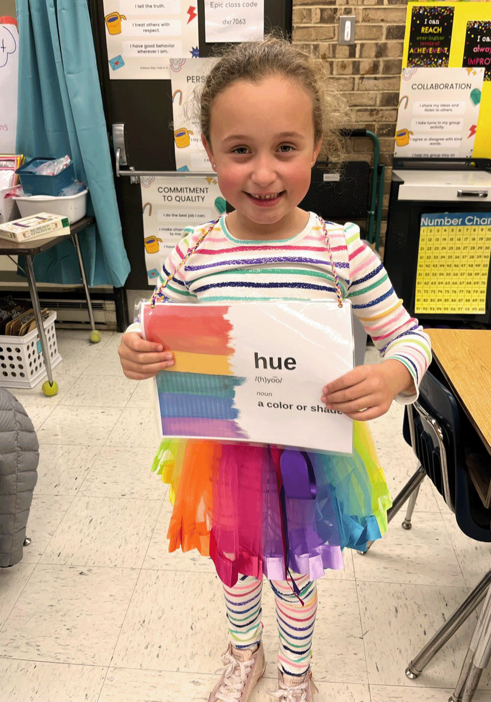 Female student holding up her art work