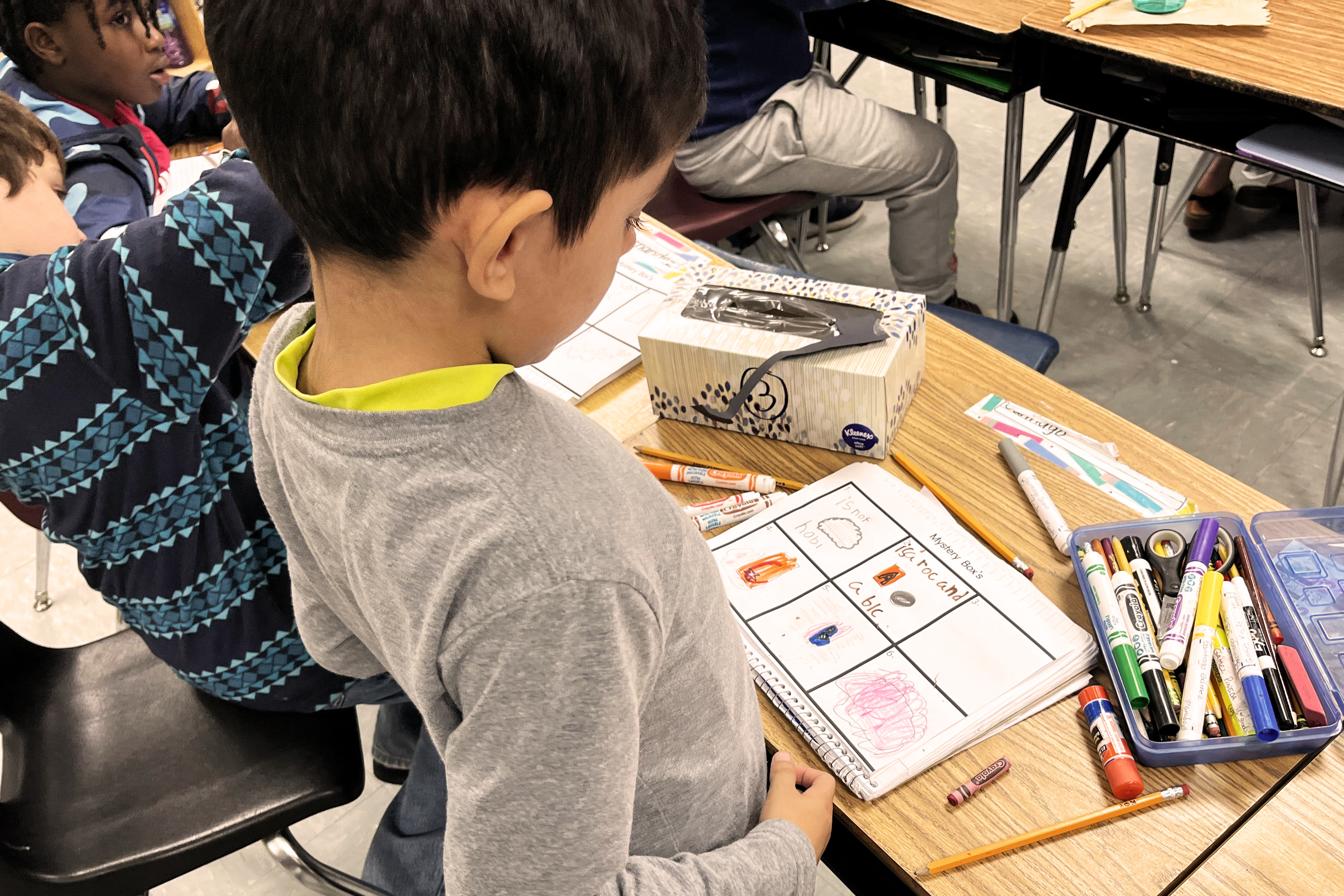 A student writing in his notebook