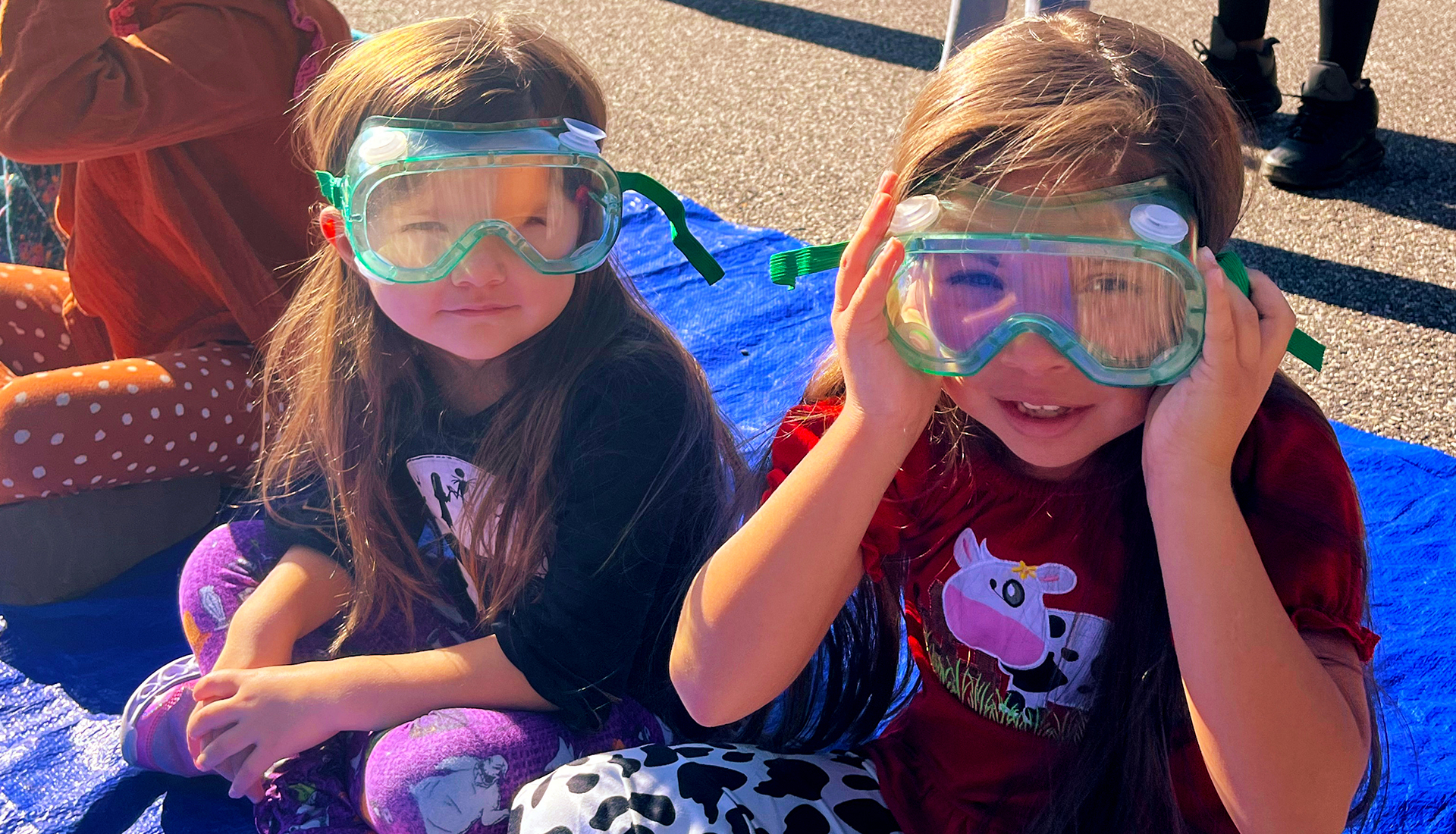 Two girls wearing safety goggles