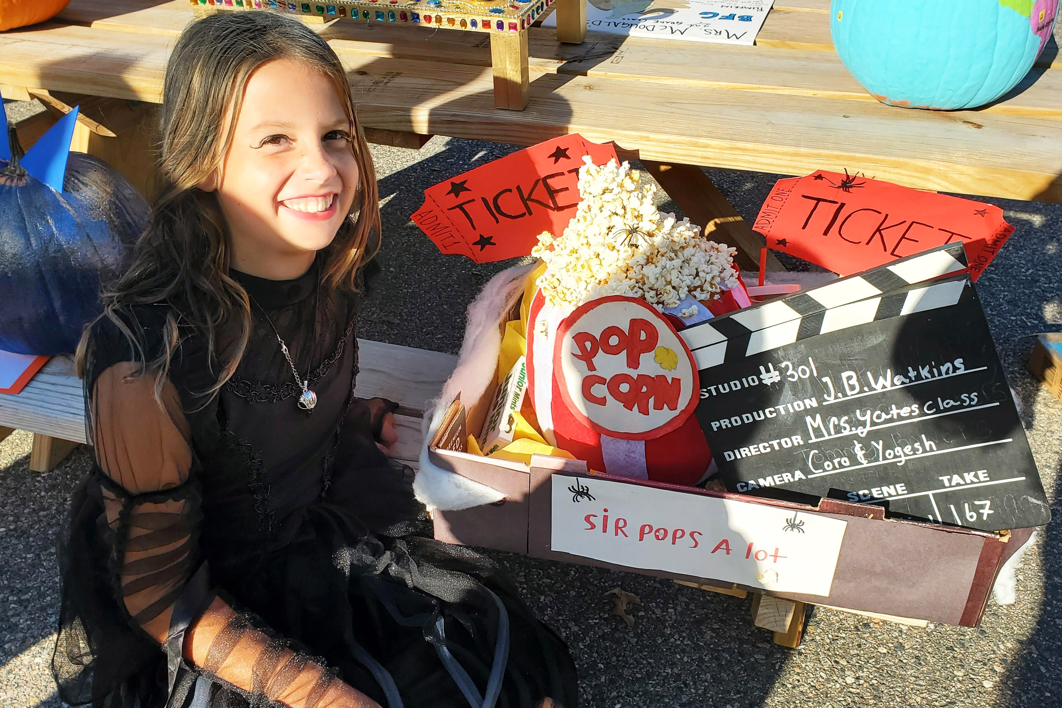 A girl sitting in front of a basket with popcorn