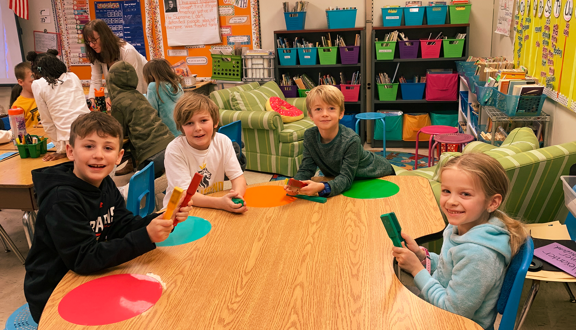 Second graders sitting together at a table in class