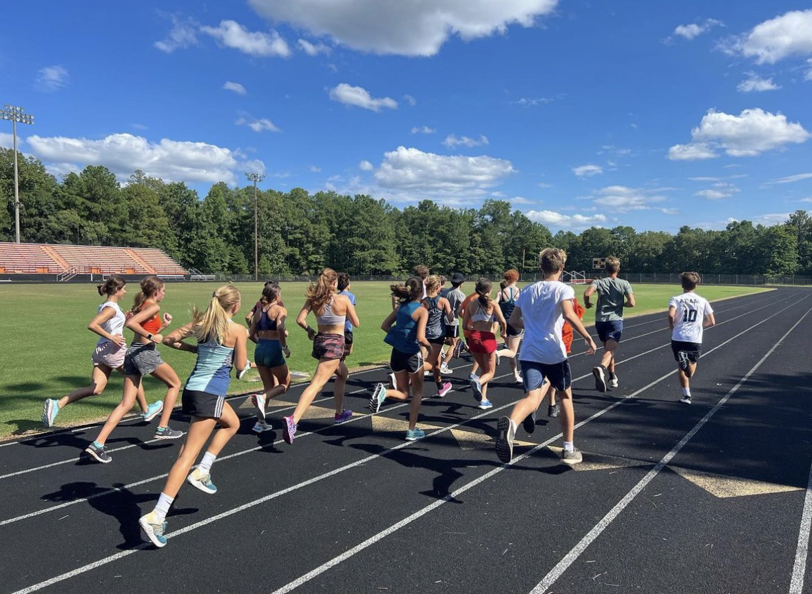 The cross country team running on the school track