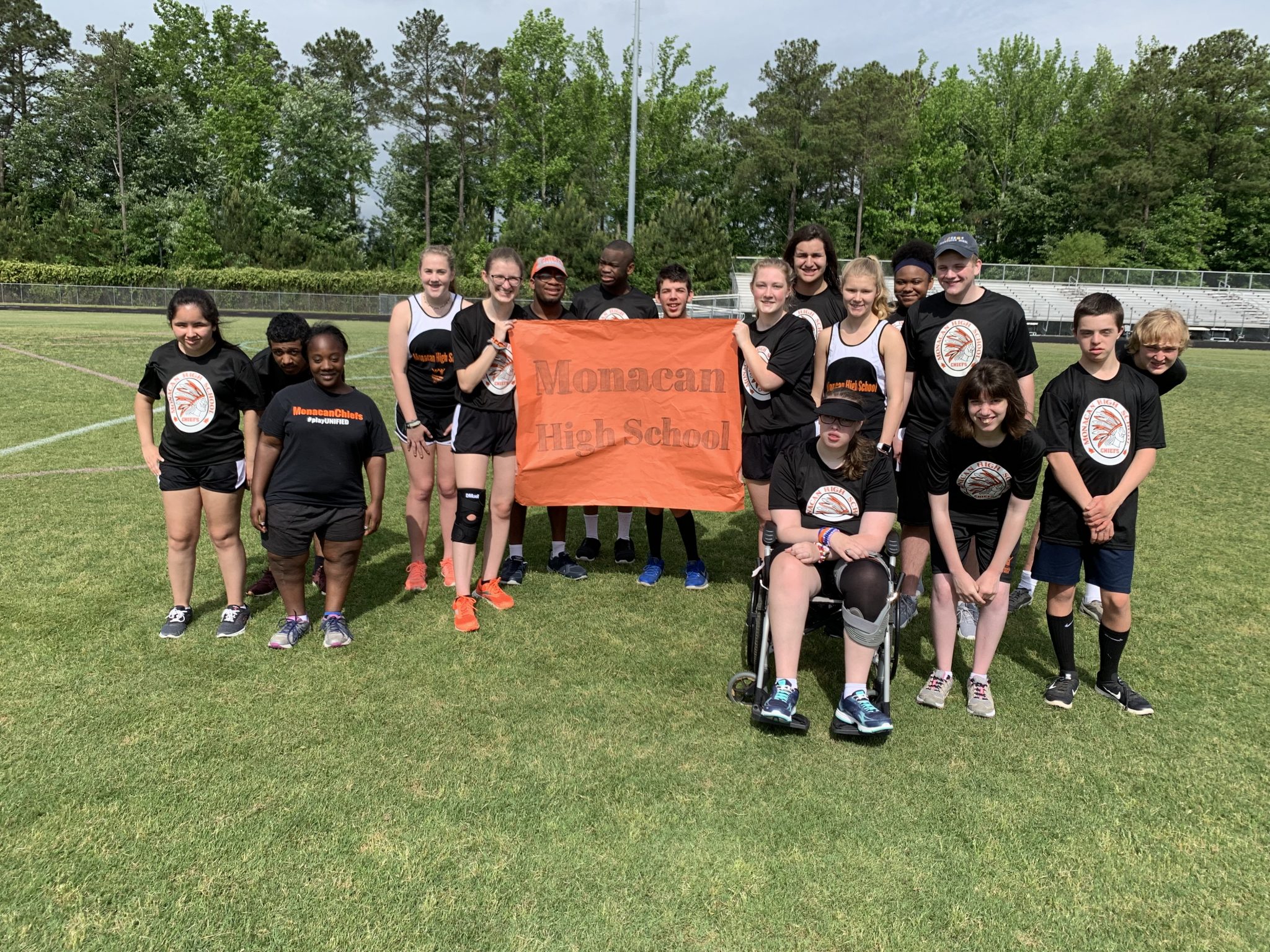 Members of the Champions Together Unified Sports club pose for a photo on the field