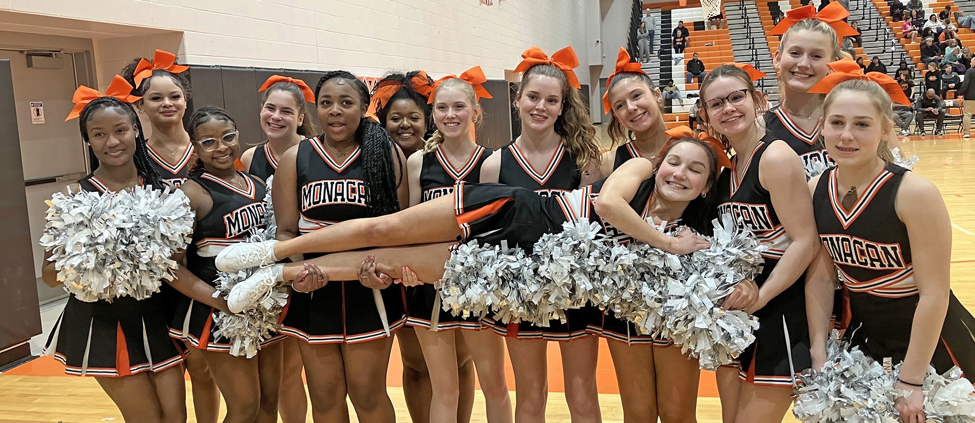 Cheerleaders pose for a photo