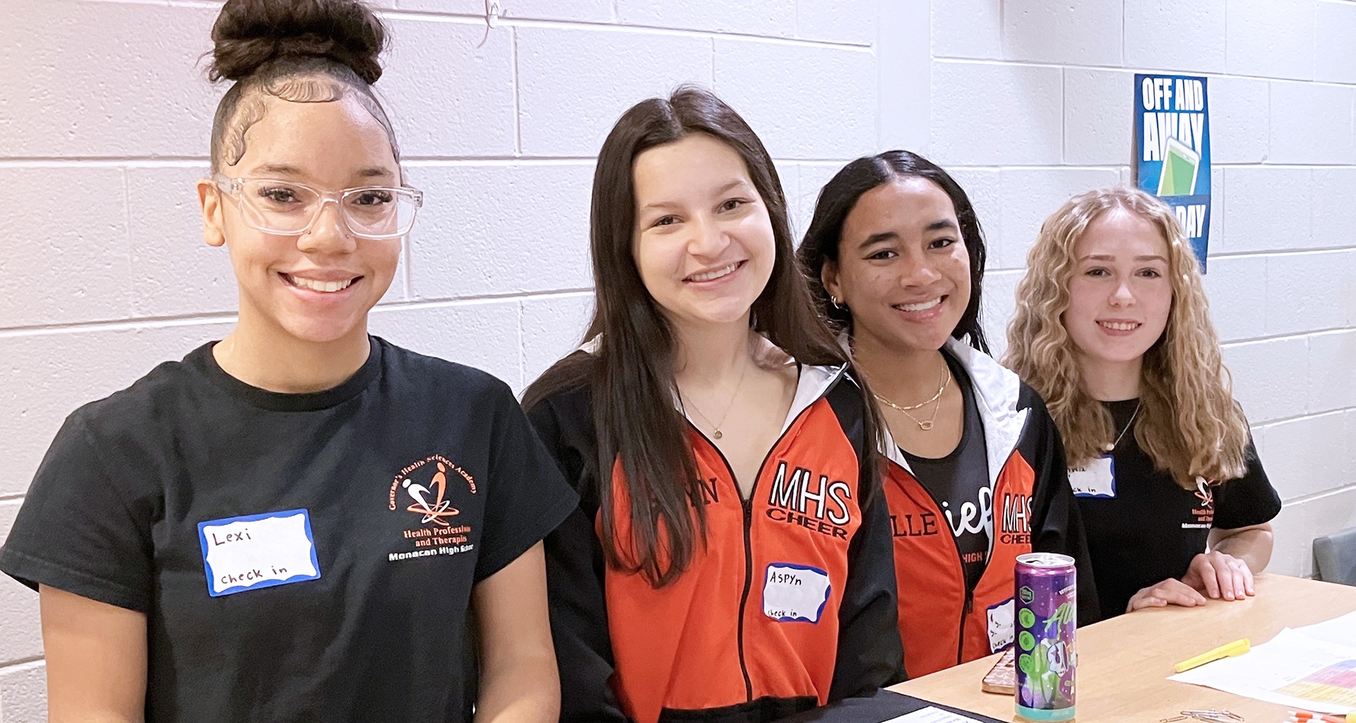 Four students smile for a photo