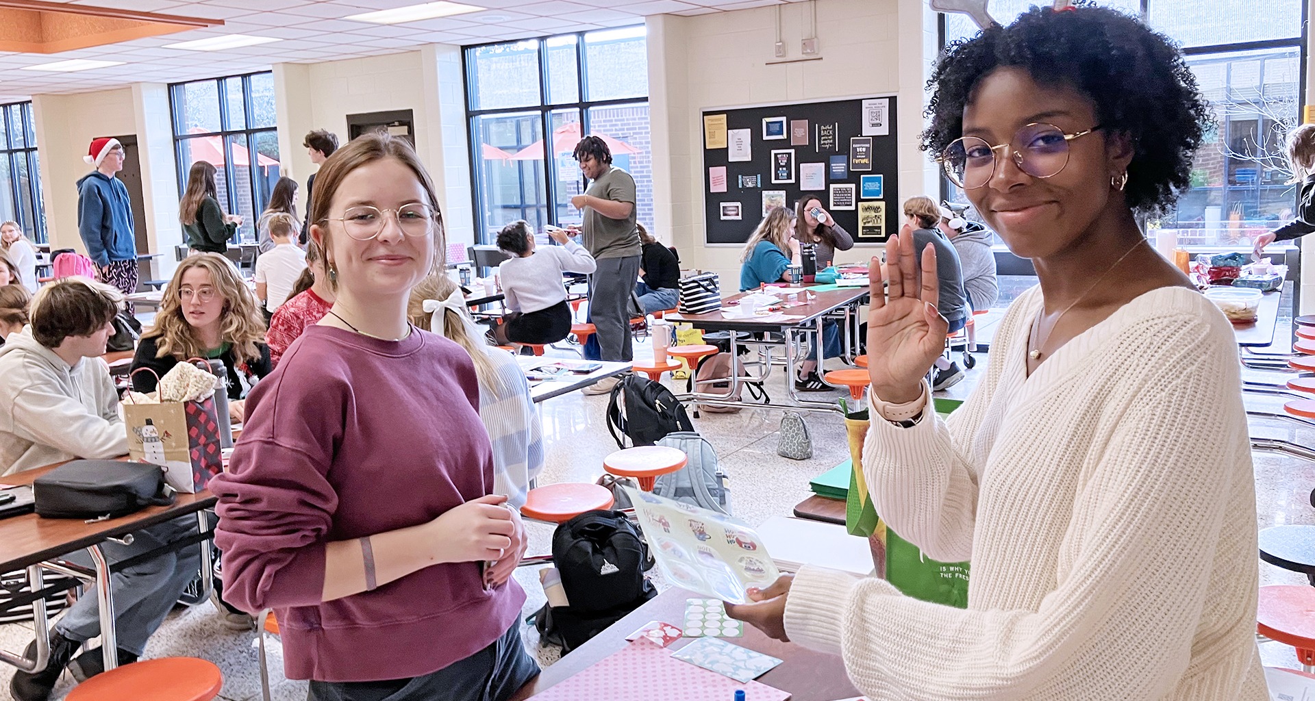 Two students smile for the camera