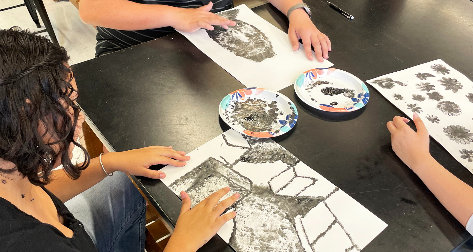 students painting with fingers