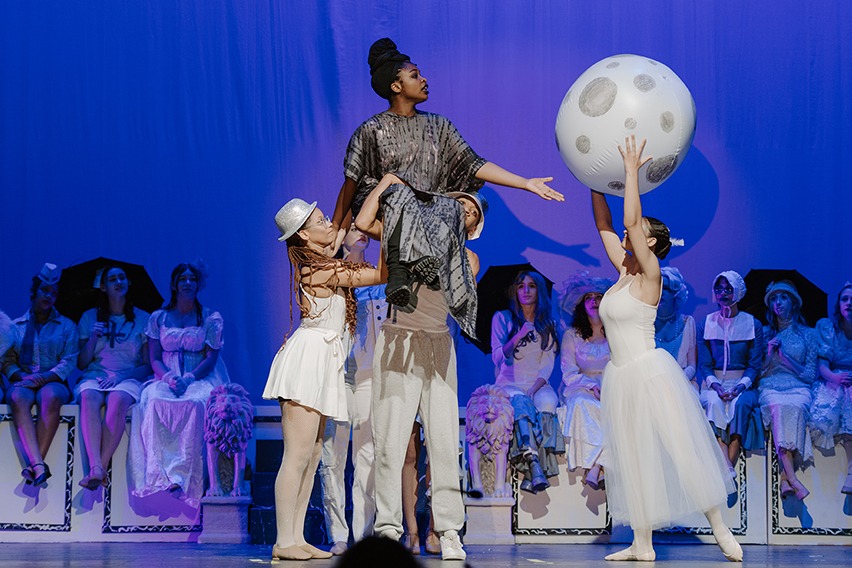 students onstage during play