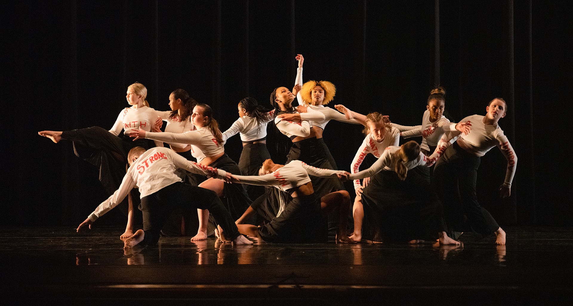 Students dance on stage during performance