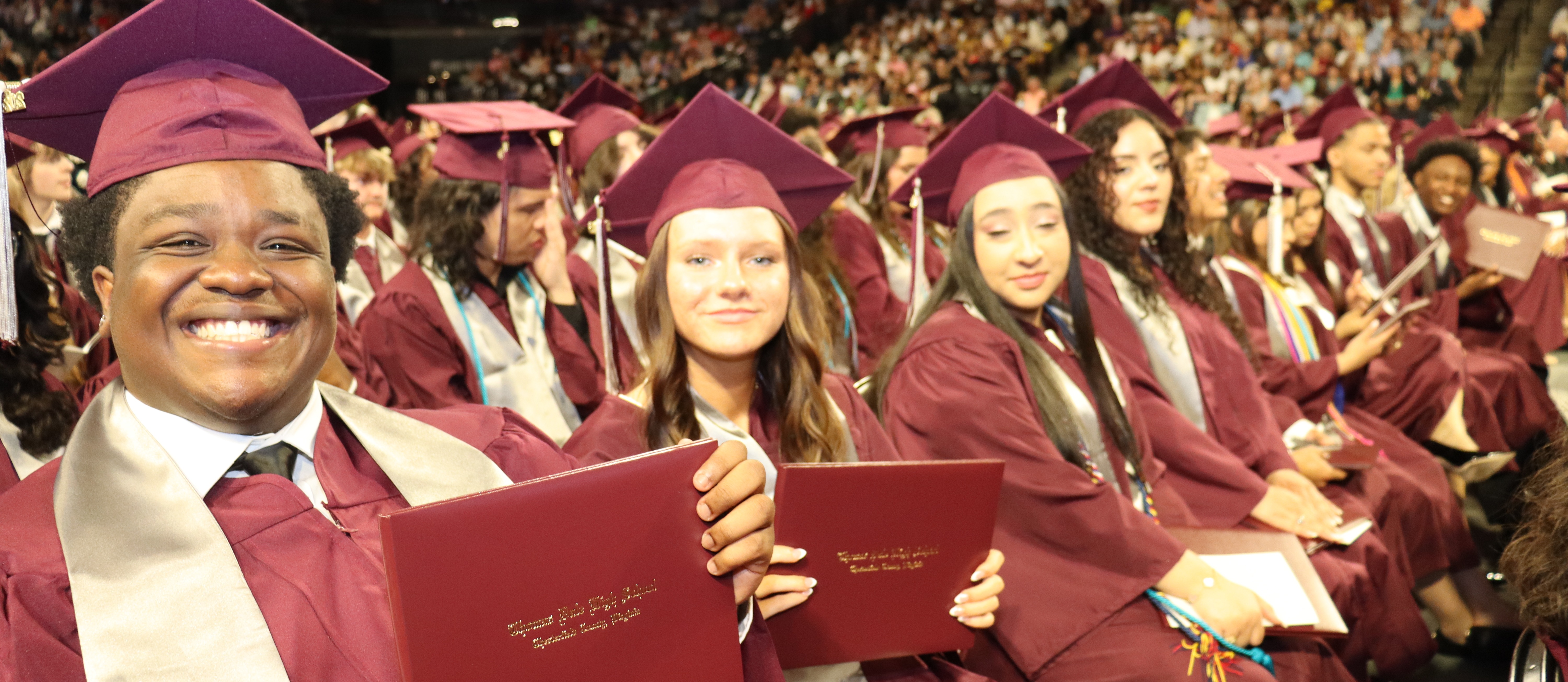 grads smile for a photo
