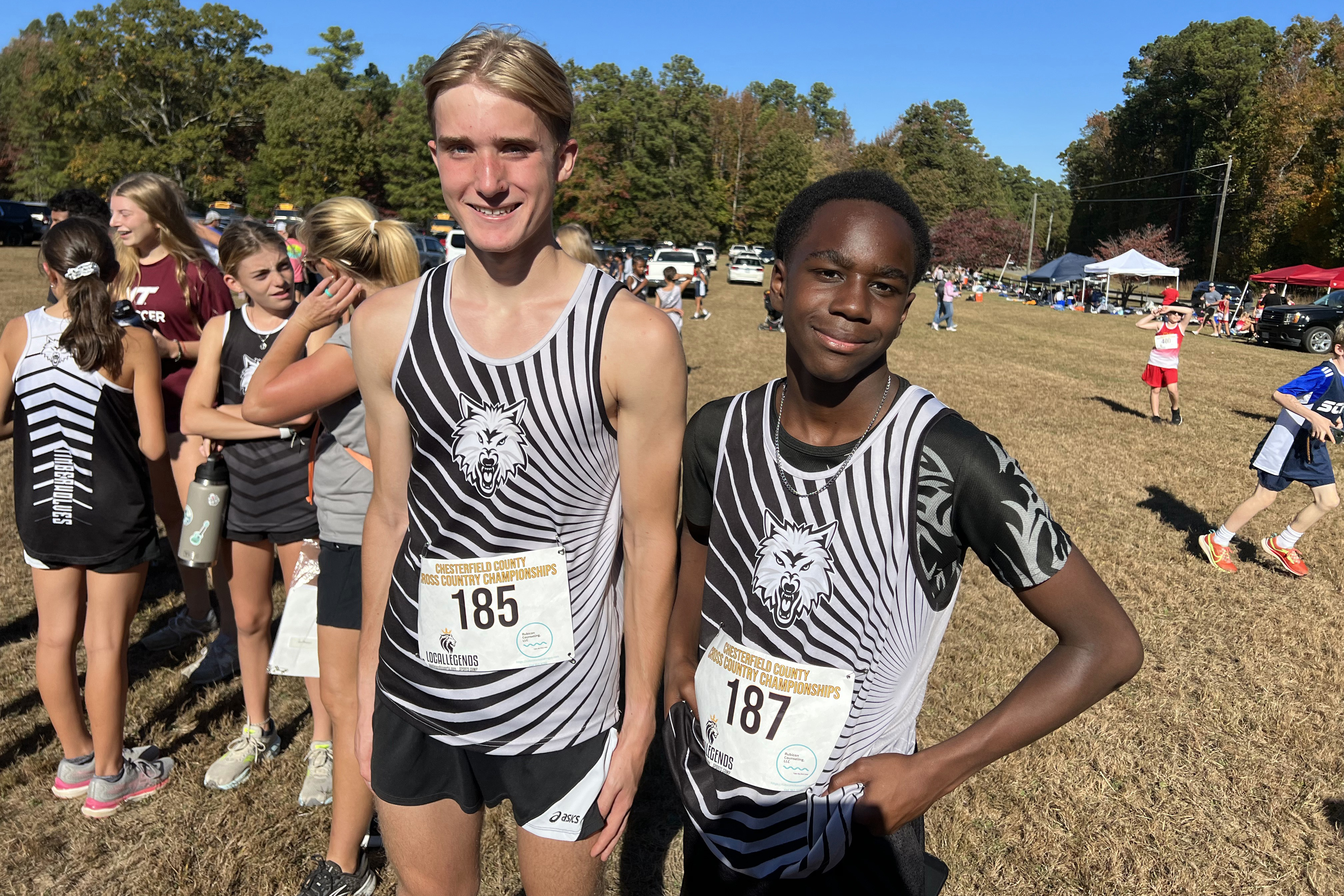 Two cross country runners smile for a photo